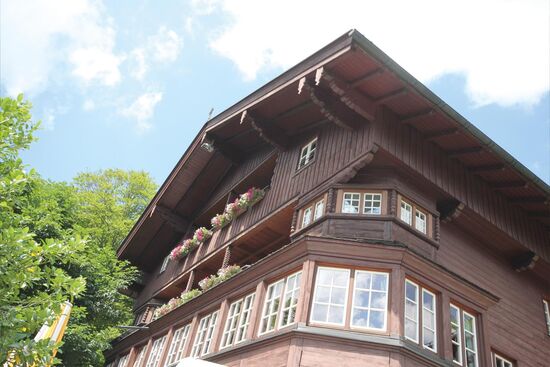 Berghotel Sudelfeld Bayrischzell view to facade old hotel building blue sky and clouds